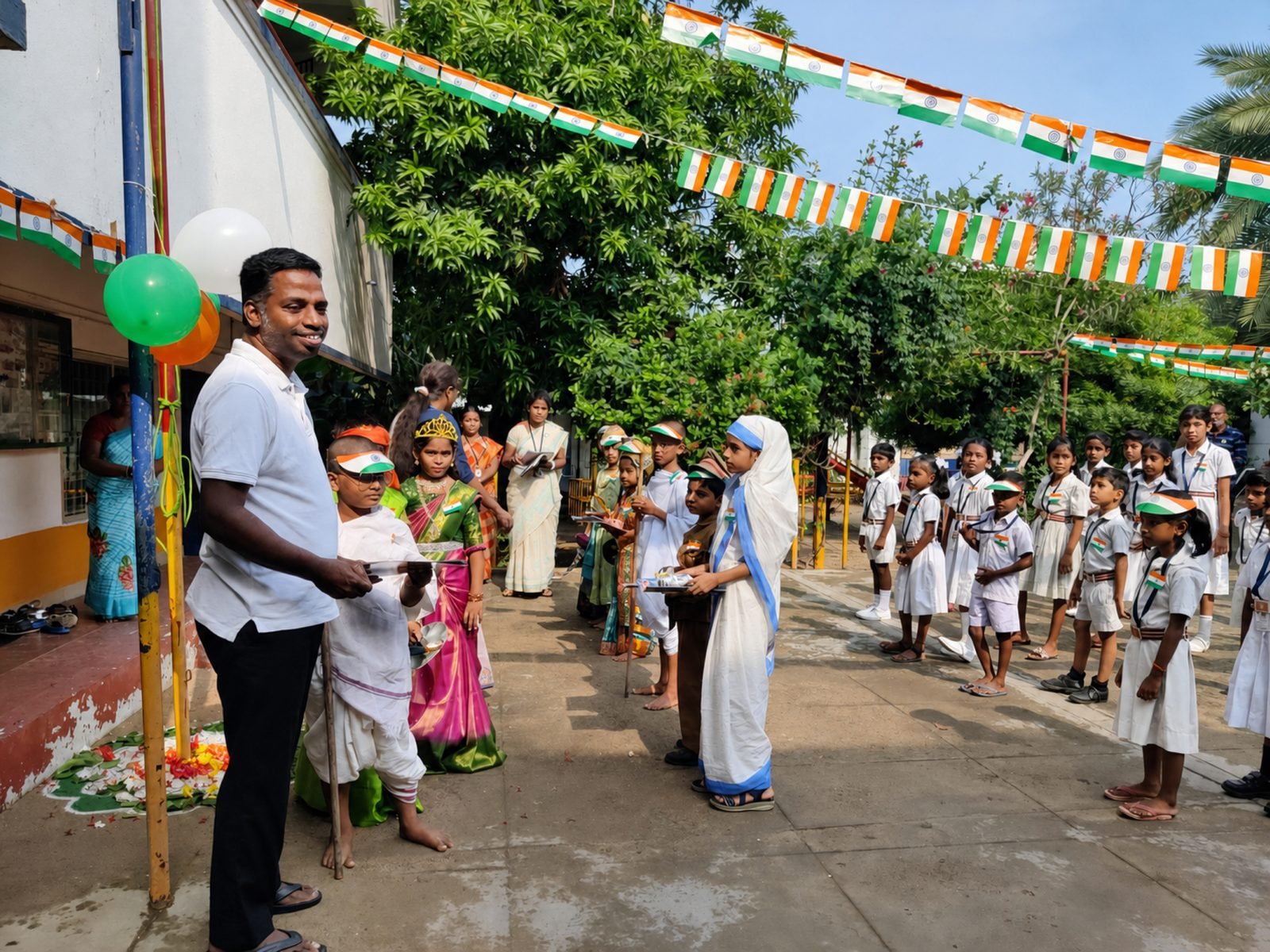 Children in fancy dress as historical figures at an Independence Day celebration, under tricolour bunting