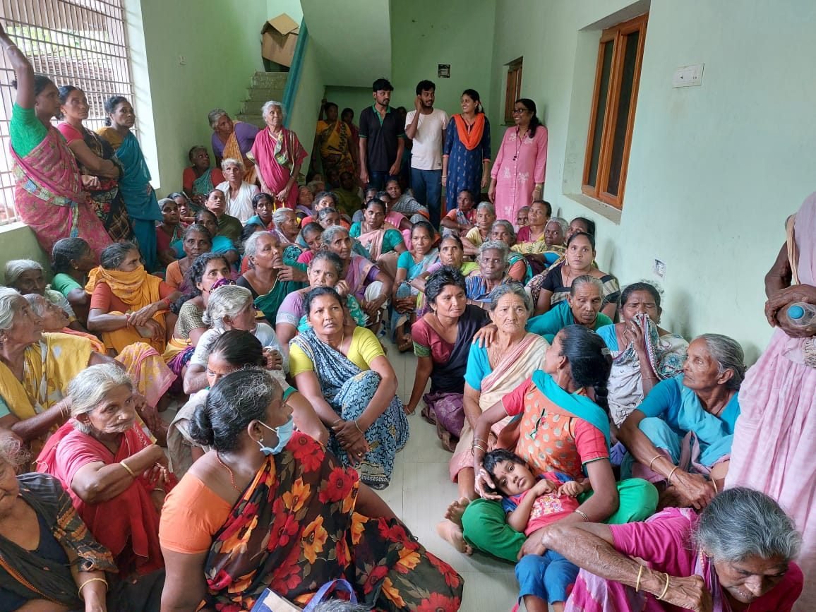 Widows seated together in a hall in Nellipudi, waiting at a Bethel Mission distribution day
